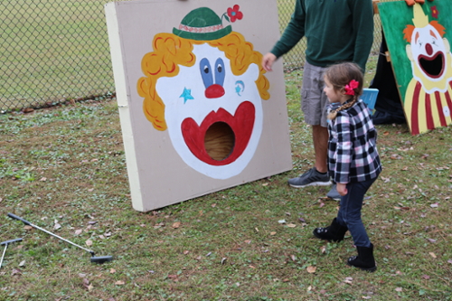 Child playing bean bag toss
